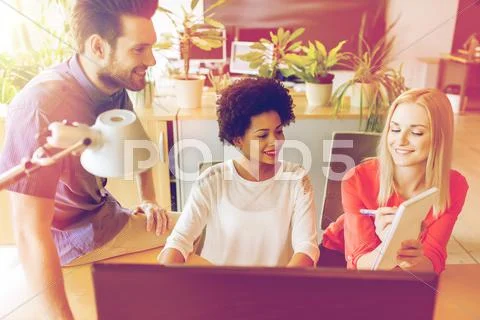 Happy creative team with computer in office Stock Photos
