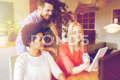 Happy creative team with computer in office Stock Photos