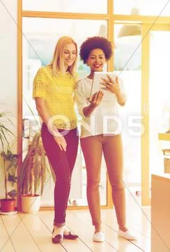 Happy creative team with tablet pc in office Stock Photos