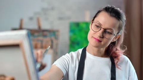 Happy creative young female painter focused working at art studio medium close Stock Footage 109046471