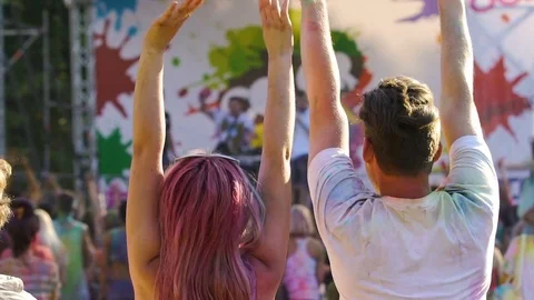Happy crowd enjoying performance at outdoor festival, jumping with hands up Stock-Footage 70201932