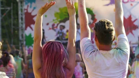 Happy crowd enjoying performance at outdoor festival, jumping with hands up Stock Footage 70203595