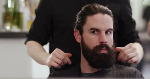 A happy customer after having his hair trimmed at a hair salon. Shot on RED Epic Stock Footage 59737978