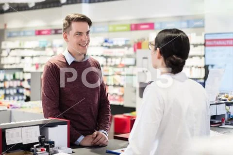 Happy customer listening to the recommendations of a reliable pharmacist Stock Photos