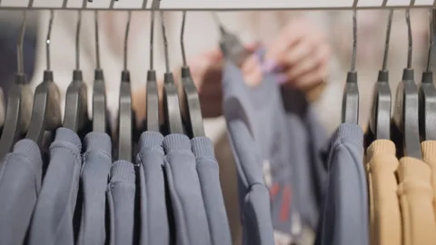 Happy Customer Selects Thick Polo From Rack On Black Hangers Stock Footage 316811450
