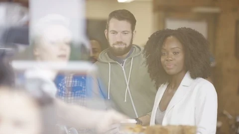Happy customers making payment at counter of coffee shop Stock Footage 108012136