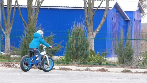 Happy cute boy learn to ride a bike with his mother. Stock Footage 125311766
