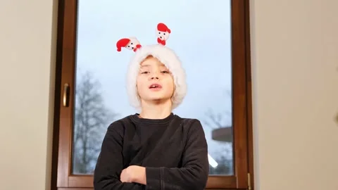 Happy cute boy in red Santa hat, holiday eve. Stock Footage 167355705