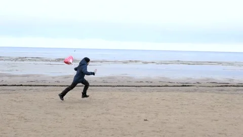 Happy cute boy standing with red ballon heart Stock Footage 146043215
