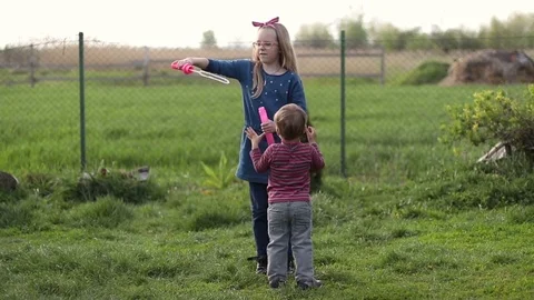 Happy cute children playing with bubbles in yard Stock-Footage 75308472