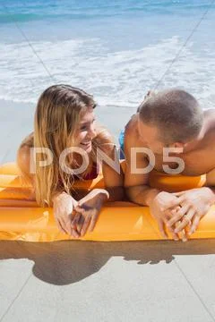 Happy cute couple in swimsuit looking at each other Stock Photos
