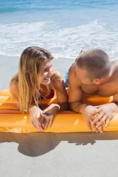 Happy cute couple in swimsuit looking at each other Stock Photos