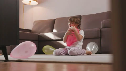 Happy Cute Girl Playing with Balloons at Home. Child Gives Hugs to Balloon Video stock 232939853