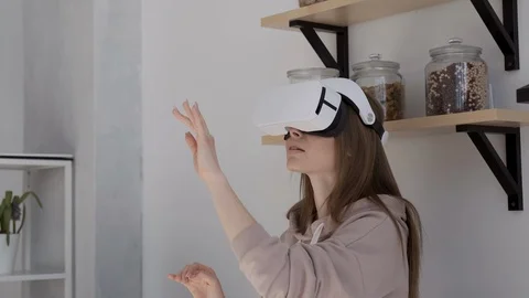 Happy cute girl using 3D virtual reality headset. Virtual reality game. Stock Footage 107935472