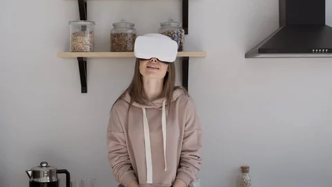 Happy cute girl using 3D virtual reality headset. Virtual reality game. Stock Footage 107936801