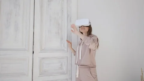 Happy cute girl using 3D virtual reality headset. Virtual reality game. Stock Footage 107936979