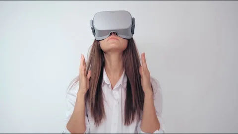 Happy cute girl using 3D virtual reality headset. Virtual reality game. Woman Stock Footage 125976100