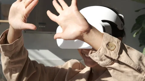 Happy cute girl using 3D virtual reality headset. Virtual reality game. Stock Footage 250403076