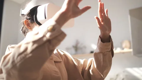 Happy cute girl using 3D virtual reality headset. Virtual reality game. Stock Footage 250403249