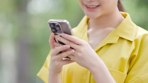 Happy cute girl using map application on mobile phone while standing on modern c Stock Footage 246696374