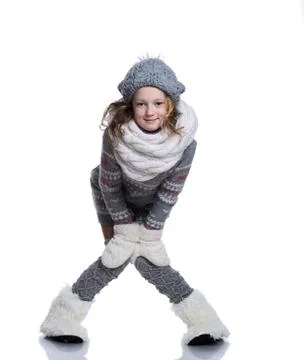 Happy cute kid posing in the studio isolated on white background. Wearing win Stock Photos