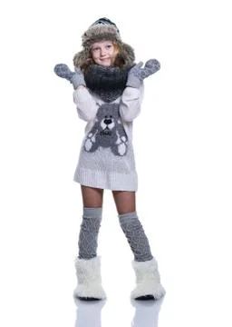 Happy cute kid posing in the studio. Wearing winter clothes. Knitted woolen s Stock Photos