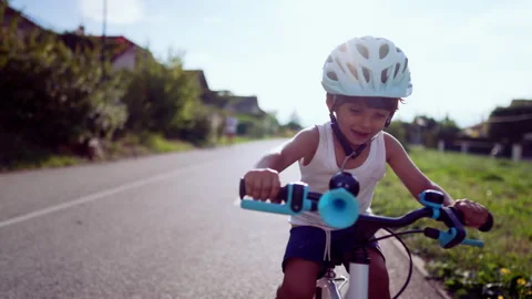 Happy cyclist kid rides bike outdoors Stock Video Pond5