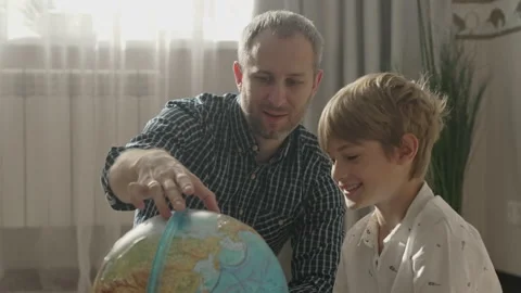 Happy dad and small kid boy looking at globe, Stock Footage 157442487