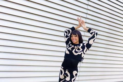 Happy dancer raising hands posing on the street Stock Photos