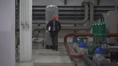 Happy dancing young engineer is in a technical room. at the factory Stock Footage 105607134