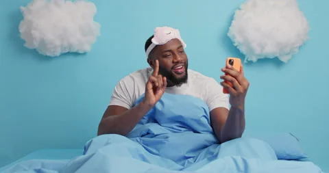 Happy dark skinned bearded man tries video calling enjoys online communication Stock Footage 148990883