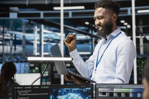 Happy data center admin celebrating after managing to setup machine learning Stock Photos