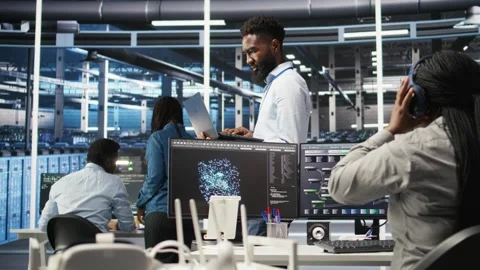 Happy data center admin uses node tree programming on laptop Stock Footage 309114999