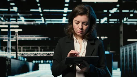 Happy data center female engineer inspecting blue wireframe mesh rigs, VFX Stock Footage 329329773