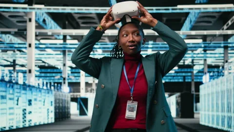 Happy data center technician using VR headset technology, pleased Stock Footage 329713839