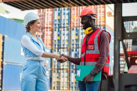 Happy dealing shaking hands two businesswoman and engineer working checking l Stock Photos