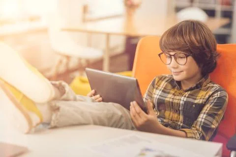 Happy delighted kid using a tablet Stock Photos