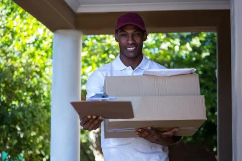 Happy delivery man with parcel 写真素材
