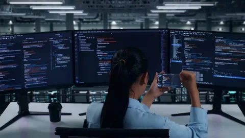 Happy Developer Looking At Code On Mobile Phone While Write Code In Data Center Stock Footage 270230128