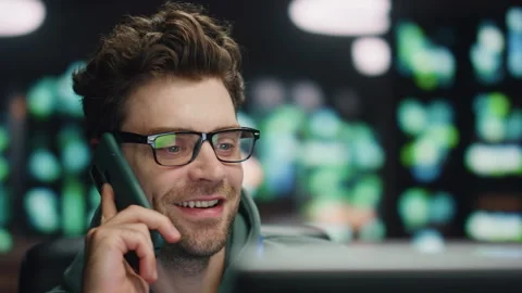 Happy developer talking smartphone at night datacenter closeup. Man ending call Stock Footage 260252706