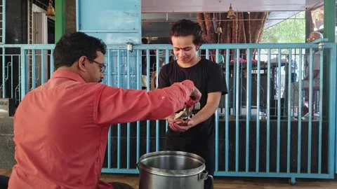 A happy devotee takes prasadam or prasad in his hands after worshipping God Video stock 243577876