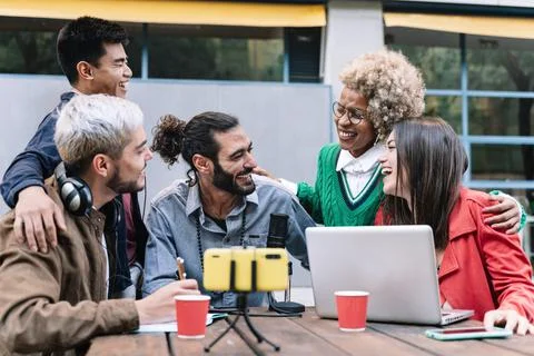 Happy digital content creators streaming live podcast online using microphone Stock Photos
