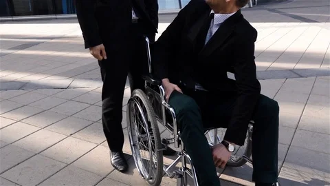 Happy disabled businessman, spending time in business district with his friend Stock Footage