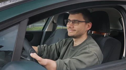Happy disabled man opens car window and smiles. A disabled person is driving. Stock Footage 268973877