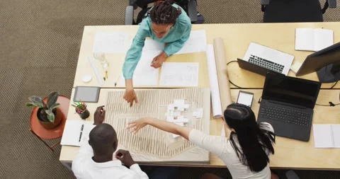 Happy diverse architects looking at architectural models at office Stock Footage 341392682