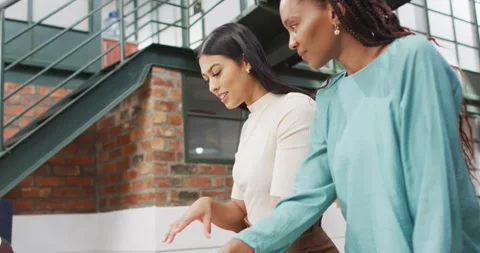 Happy diverse architects looking at architectural models at office Stock Footage 341942080