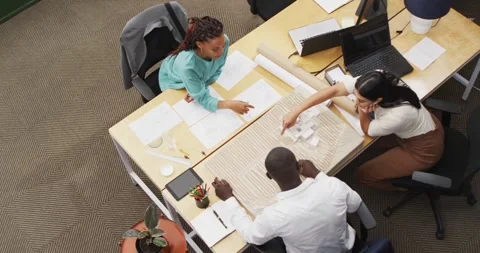 Happy diverse architects looking at architectural models at office Stock Footage 345641913