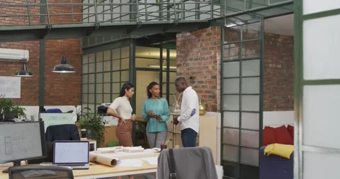 Happy diverse architects using tablet and discussing work at office Stock Footage 340609754