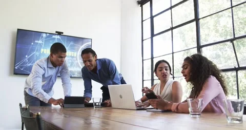 Happy diverse colleagues discussing work around laptop and celebrating in office Stock Footage 317215414
