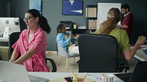 Happy Diverse Colleagues Having Fun, Spinning on Chairs in Modern Office Stock Footage 338332785